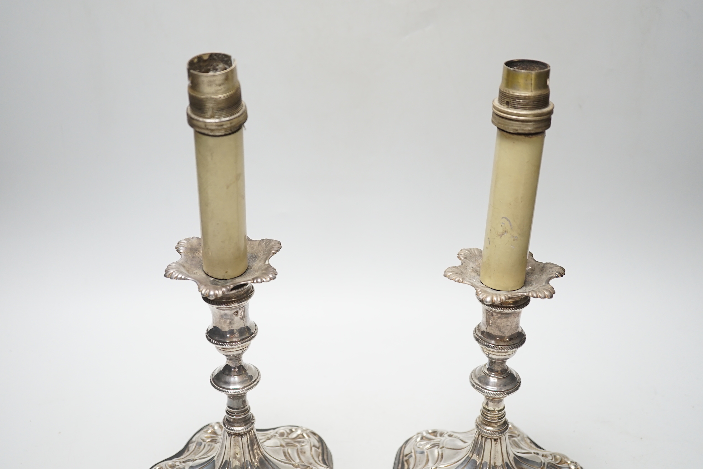 A pair of Georgian? silver candlesticks, on later wooden bases which have been drilled for electricity and later plated? sconces, sticks only, excluding sconces, are 16cm.